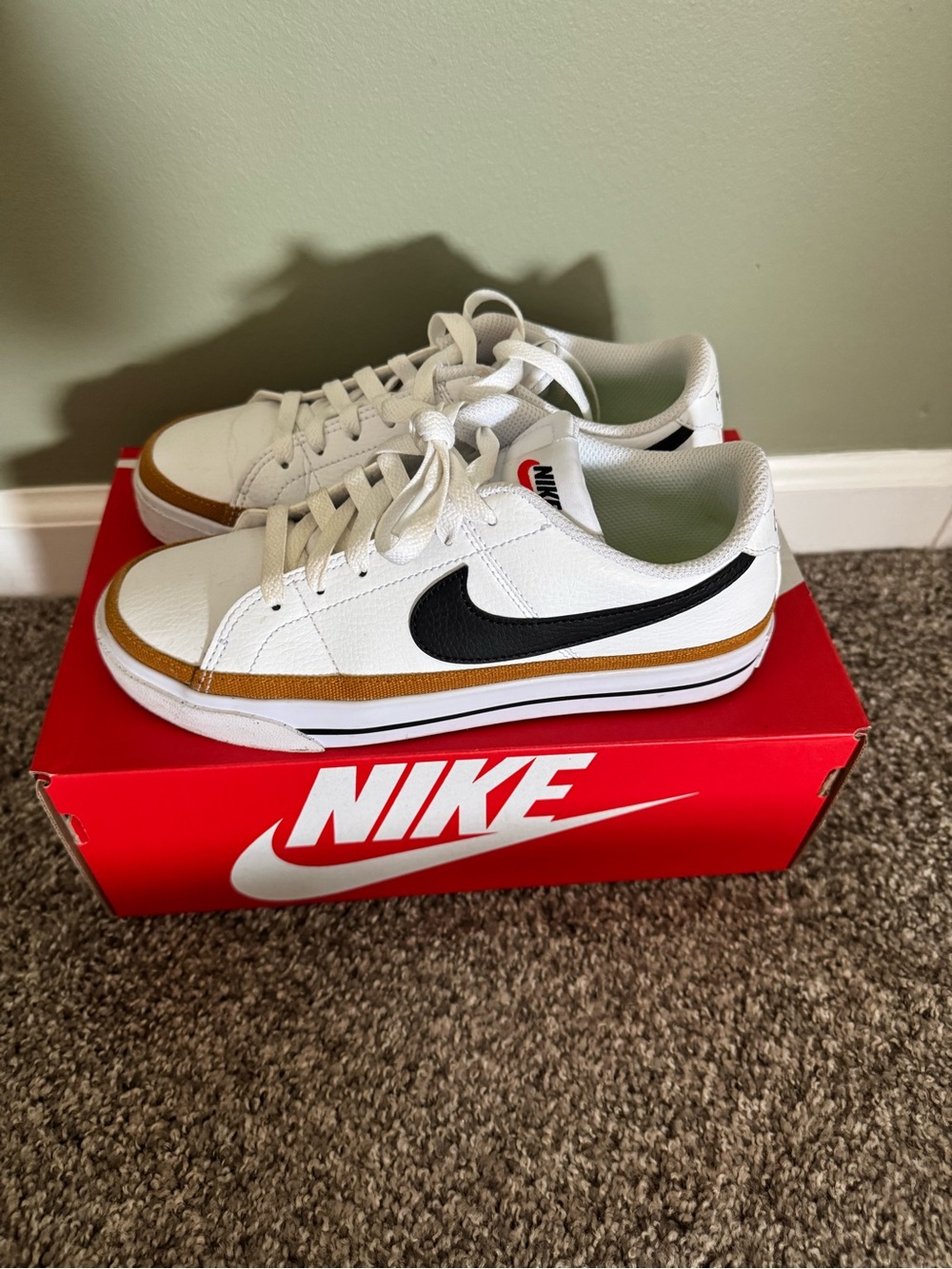 Nike White Sneakers with Black Swoosh and Gold Trim